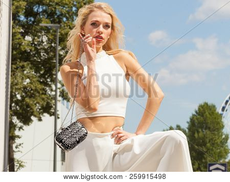 Elegant Fashionable Woman Presenting Trendy Urban Outfit. White Crop Top And Trousers Culottes. Outd