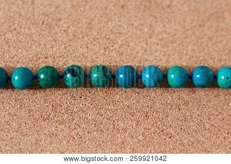 Beads From Turquoise Lie On A Box Of Cork Tree. Close-up, Macro