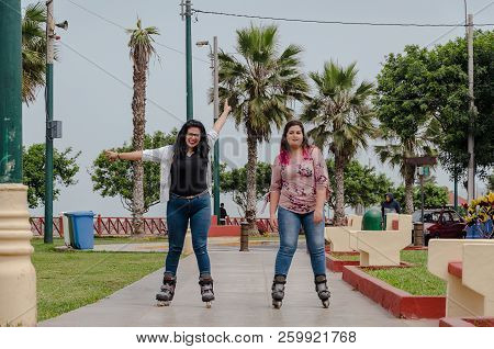 Two Chubby Girls With Inline Skates In The Park