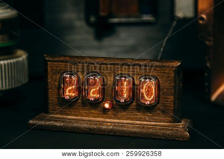 Wooden Retro Nixie Lamp Indicator Clock In Dark Room.