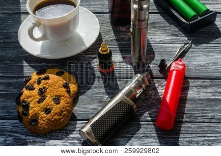 Still Life With E-ciggarete And Coffe On The Wooden Background