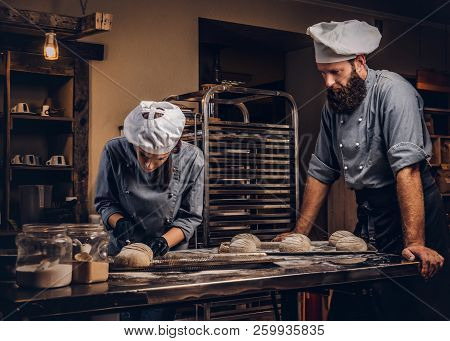 Cooking Master Class In Bakery. Chef With His Assistant Showing Ready Samples Of Baking Test In Kitc