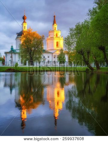 Russian ortodox church and its reflection in a pond. Boldino, Russia
