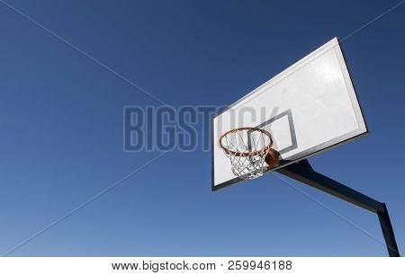 Basketball Hoop And Backboard Set Against Blue Sky