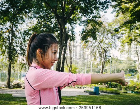 Close Up Of A Young Woman Warm Up Her Body By Stretching Her Arms To Be Ready For Exercising And Do 