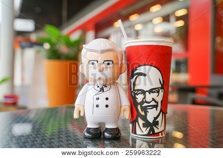 Bangkok ,thailand- September 21,2018: Colonel Harland Sanders Doll With Cold Drink In Front Of Kfc R