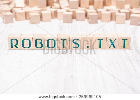 The Word Robots.txt Formed By Wooden Blocks On A White Table