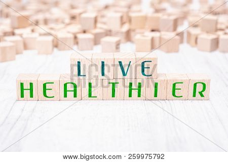 The Words Live Healthier Formed By Wooden Blocks On A White Table