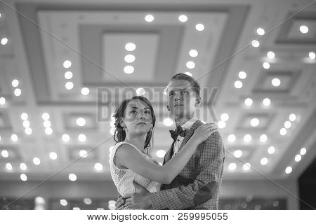 The Bride And Groom Stand On The Beautiful Porch Of The Hotel At Night
