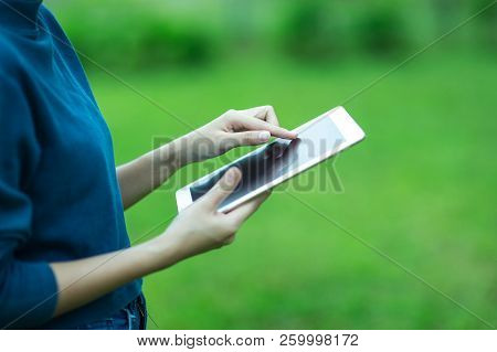 Woman’s Hand Holding Tablet
