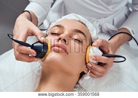Face Skin Care. Close-up Of Woman Getting Facial Hydro Microdermabrasion Peeling Treatment At Cosmet