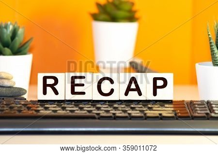 Recap Word From Wooden Blocks On Desk