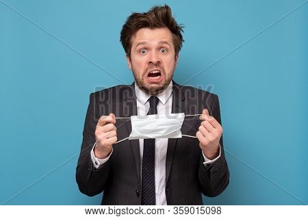 Young Handsome Man With Medical Mask Has Panic Attack. He Is Afraid He Is Infected.
