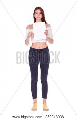 full-length portrait of a young beautiful brown hair model in black jeans, isolated on white backgr