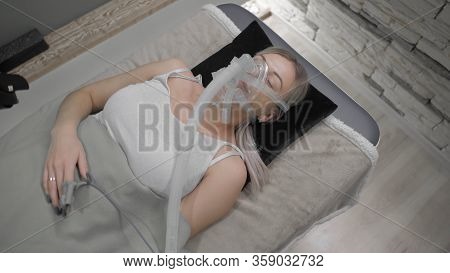 Girl Lies On Bed With Artificial Respiration Mask, Coronavirus
