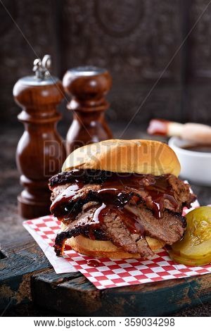 Smoked Barbeque Beef Brisket Sandwich With Pickles And Bbq Sauce