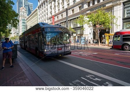 San Francisco, Ca June 8, 2019: Muni Bus Fulton Line 5 On Moving Past Person On Market Street Shoppi