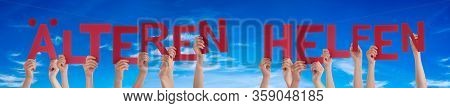 People Hands Holding Word Aelteren Helfen Means Help Elderly, Blue Sky