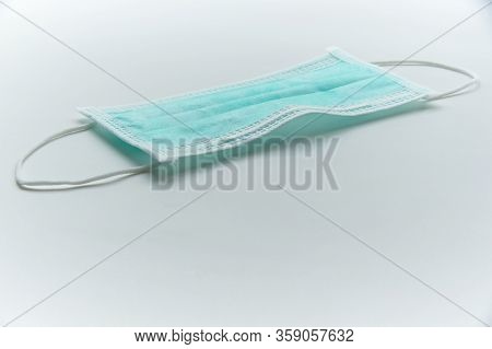 A Hygienic Green Mask With Ear Loops On The Table