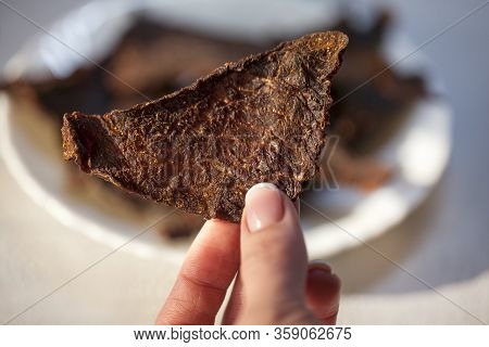 Dry Jerky Jerky. Beef Jerky In A Female Hand