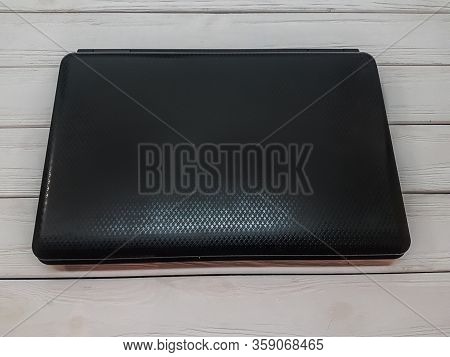 Close Up. Closed Laptop On Wooden Background.