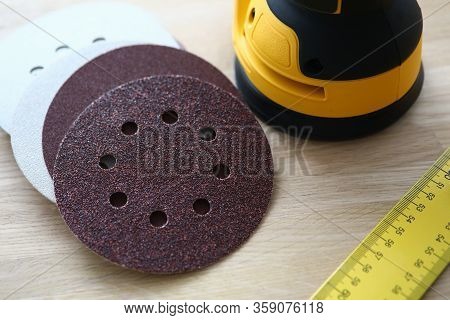 Close-up Of Sander Machine With Replacement Discs On Table. Grinding Equipment For Renovation And Co