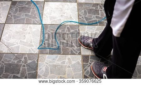 View From Leg Of A Woman Using The Jump Rope To Exercise At Home.