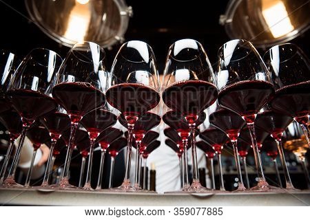 Glasses Of Red Wine Are On The Table, Ready To Serve.