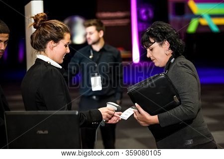 Delegate Guests Signing In At Registration At Convention Center Event