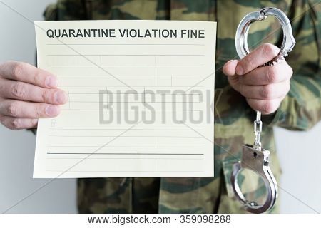 Police Officer With Handcuffs In Khaki Colored Uniform Stops People On The Street For Violating Rule