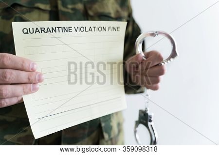 Police Officer With Handcuffs In Khaki Colored Uniform Stops People On The Street For Violating Rule