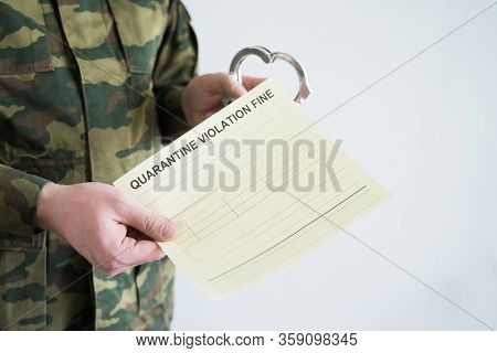 Police Officer With Handcuffs In Khaki Colored Uniform Stops People On The Street For Violating Rule
