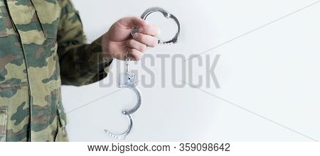 Police Officer With Handcuffs In Khaki Colored Uniform Stops And Arrest Criminal On The Street For V