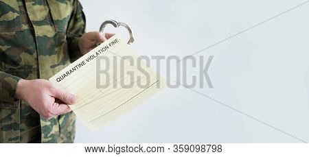 Police Officer With Handcuffs In Khaki Colored Uniform Stops People On The Street For Violating Rule