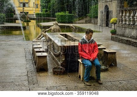 Salzburg, Austria - May 28, 2019: A Tour Group Volunteer Sits On The Archbishop Seat As The Trick Fo