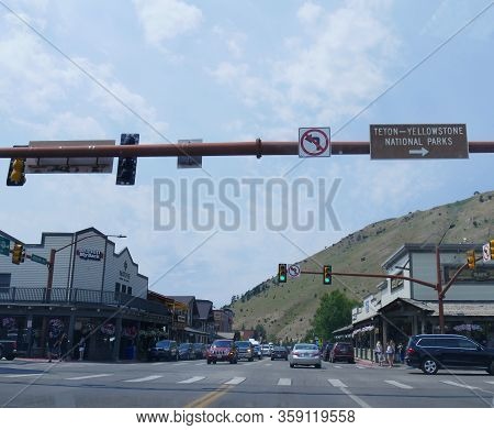 Jackson Hole, Wyoming- August 2018: Wide Street Shot With Cars Traveling On A Green Light In Jackson