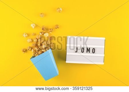 Abbreviation Word Jomo Written On A Decorative Board On A Bright Yellow Background. The Concept Of R