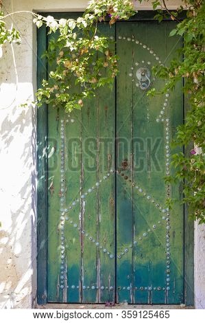 Traditional Green Arabian Door In A Tunisian Garden