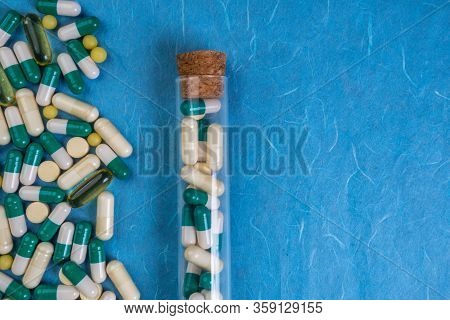 Medical Pills, Capsules, Tablets Spilling Out From Bottle On Blue Background, Pastic Transparent Con