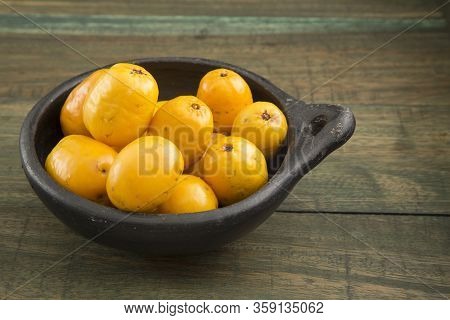Spondias Purpurea - Delicious Tropical Fruit. Wood Background