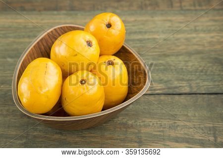 Spondias Purpurea - Delicious Tropical Fruit. Wood Background