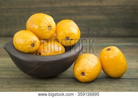 Spondias Purpurea - Delicious Tropical Fruit. Wood Background