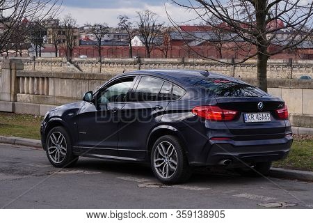 Krakow, Poland 23.02.2020: Black Bmw X4 Expensive German Car On A City Street . Parking On The Road.