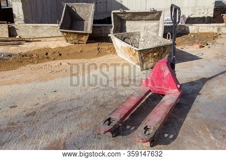 The Red Hydraulic Trolley For Transporting Heavy Loads. Transportation Equipment