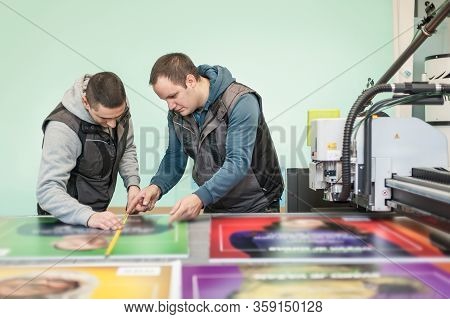 Worker Printmaker Measures And Checks Dimension With Ruler And Meter