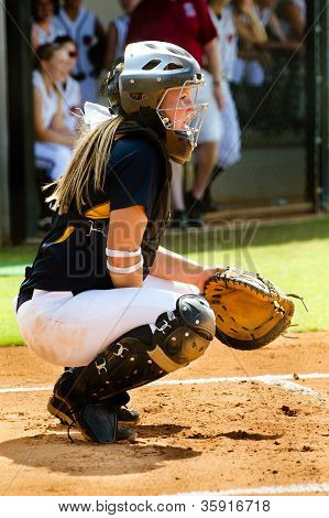 Teen girl playing softball in organized game