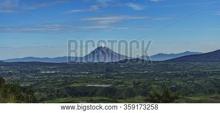 Gunung Sinabung Active Volcano Mountain Seen From Lake Toba. Beautiful Scenery Karo Batak Farm Lands