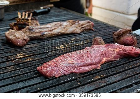 Delicious Piece Of Meat, Striploin On A Charcoal Barbeque.