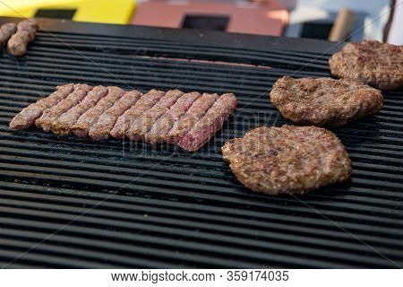 Delicious Minced Meat Cevapcici And Pleskavice On A Grill.