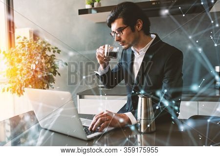 Businessman Works From Remote At House With A Laptop Due To Coronavirus Quarantine.